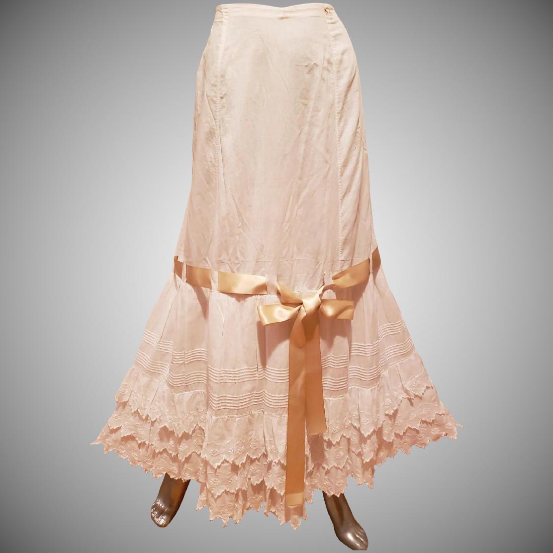 Edwardian Lawn Petticoat cotton Lace ribbon bow: Lawn Cotton Petticoat with lace and hand embroidery work on layers . String tie waist so is adjusted to many sizes. Ribbon and bow tie. maxi length. Minor wear for its age and amazingly beautiful Plea