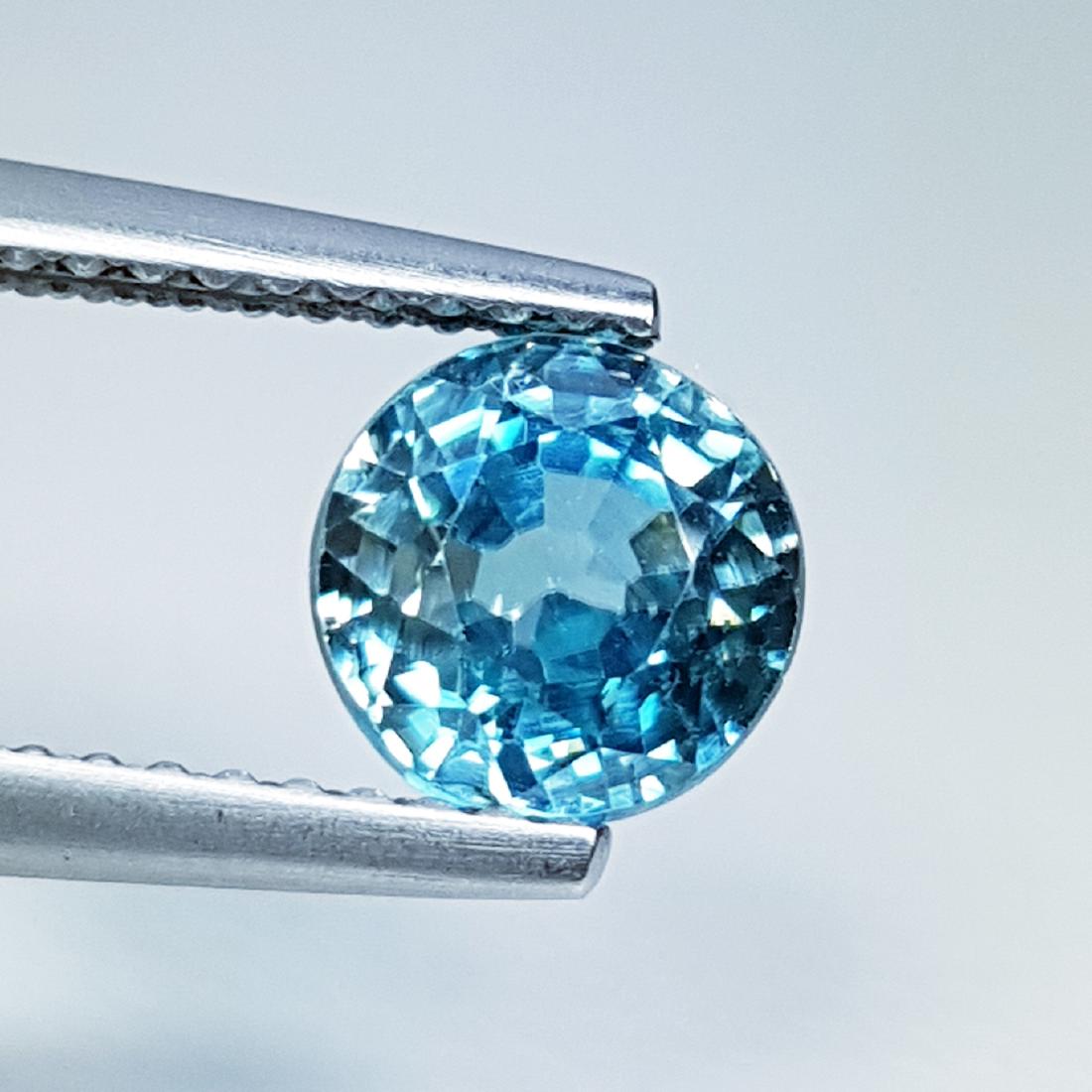 Natural Blue Zircon - 2.22 ct: Item: Natural Blue Zircon - 2.22 ct Loose Gemstone: Zircon Color/Clarity: VS Carat Weight: 2.22 Size (mm): 6.55 x 6.50 x 4.75 Round - Cambodia No Reserve: This lot starts at $1 and has no reserve as a