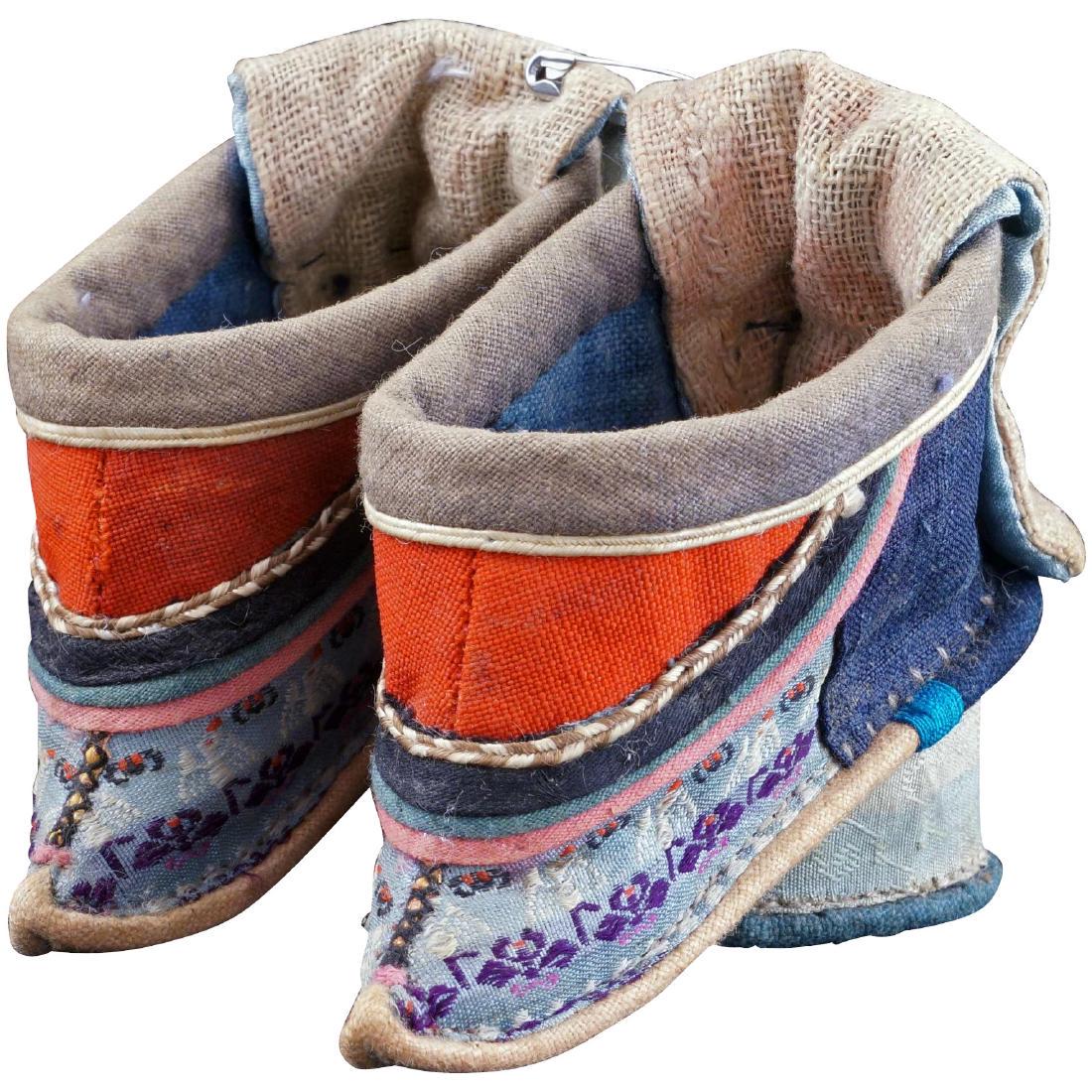 Chinese Qing very tiny silk bound feet shoes with: Reserve Reduced! Unusual bound feet shoes with raised heels and fabric over hang flaps at the back. They are in excellent condition.; This pair of shoes are made from cotton and silk with turquoise br