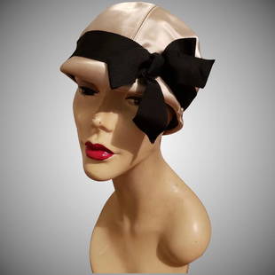 Vtg 1950's Lilly Dache "Dachettes" Cloche satin Hat: Rare Champagne one of a kind cloch hat by famous Lilly Dache "Dachettes" Cloche with black Grosgrain ribbon and bow. A real bauty. Interior circumfrnce is at : 21.5" Hem to center top- 7.5" Reserve: $