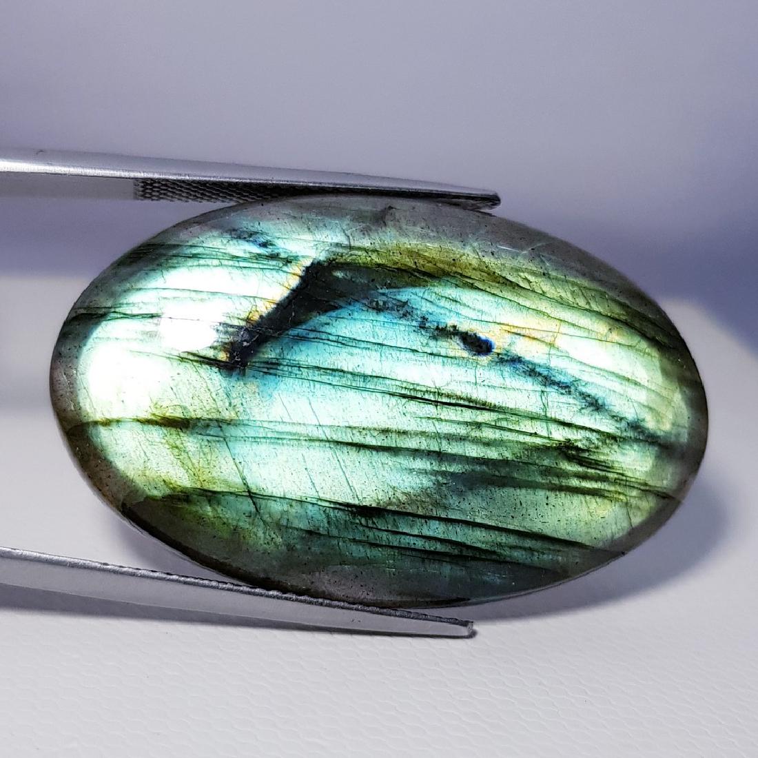 53.40 ct Natural Labradorite: No Reserve! Item: 53.40 ct Natural Labradorite Color/Clarity: Opaque Loose gemstone Carat Weight: 53.4 Size/Dimensions: 39.24 x 24.17 x 6.73 Oval - USA Shipping: Domestic: Flat-rate of $10.00 to anywh