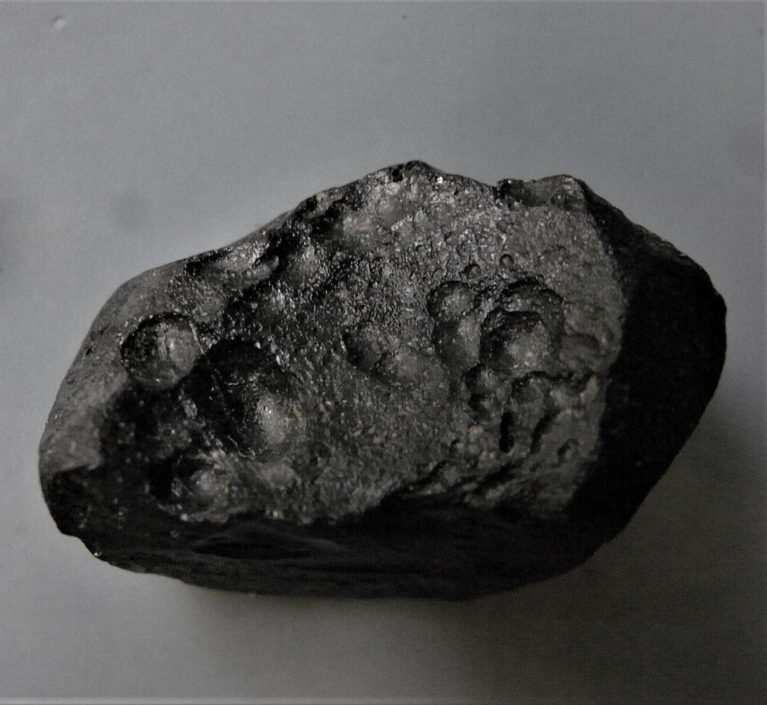 THAILANDITE TEKTITE - FROM METEORITE IMPACT: Title: THAILANDITE TEKTITE - FROM METEORITE IMPACT Origin: Noen Sa-Nga, Chaiyaphum Province, Thailand Size: 2.5x1.4x1 cm / 5 gram irregular shaped thailandite tektite. Variably pitted, one side smooth