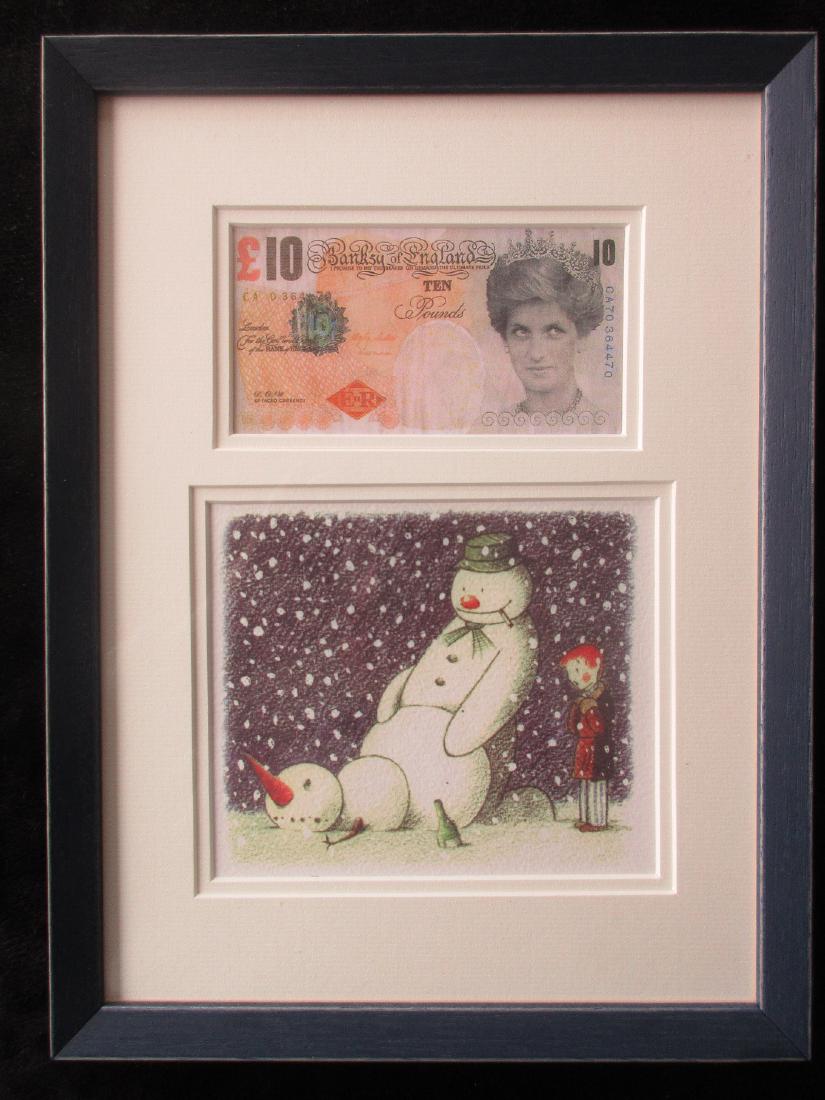 Banksy Difaced Tenner & a Banksy Rude Snowman Christmas: Banksy after Difaced Tenner and a Banksy Rude Snowman Christmas card framed. These two items are being sold as after Banksy. Framed in a new wooden frame with glass on both sides. Both items are in mi