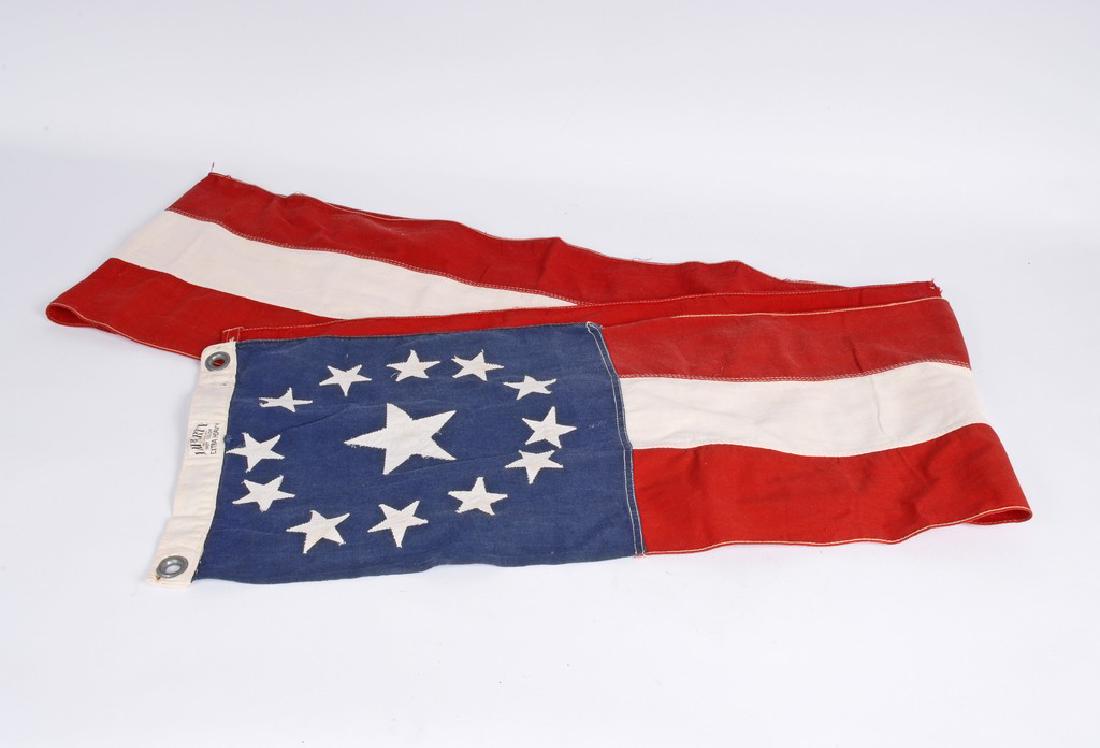 American Flag Banner: American Flag Banner - 13 stars subbounding a single star Liberty Flag company 'Extra Heavy'. Good condition with 1 small tear. 112" wide x 11" high Shipping: Domestic: Flat-rate of $18.00 to anywhere