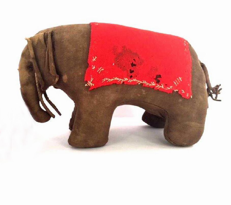 Early Pennsylvania Amish or Mennonite Stuffed Elephant: This chubby critter is just full of charm, is all meticulously hand stitched and probably dates from the later 19th century. His amusing tail is fringed at the bottom and his long floppy ears roll in 