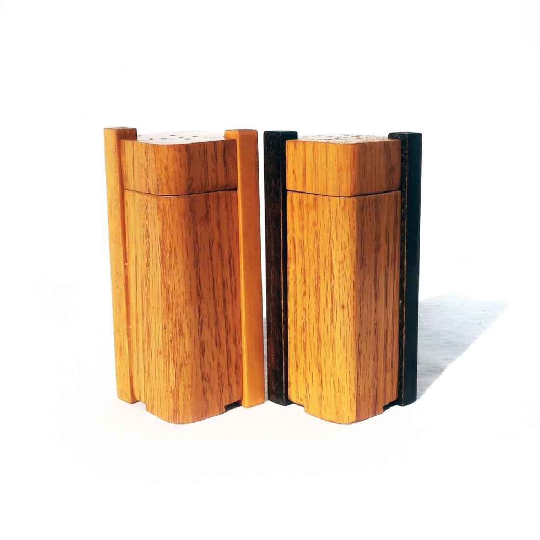 Art Deco Oak Salt & Pepper Shakers: A graceful pair of Art Deco oak salt and pepper shakers. The genius of the design is that the tops slide up and down on rails to allow refiling. The pepper shaker has black rails and the salt has natu
