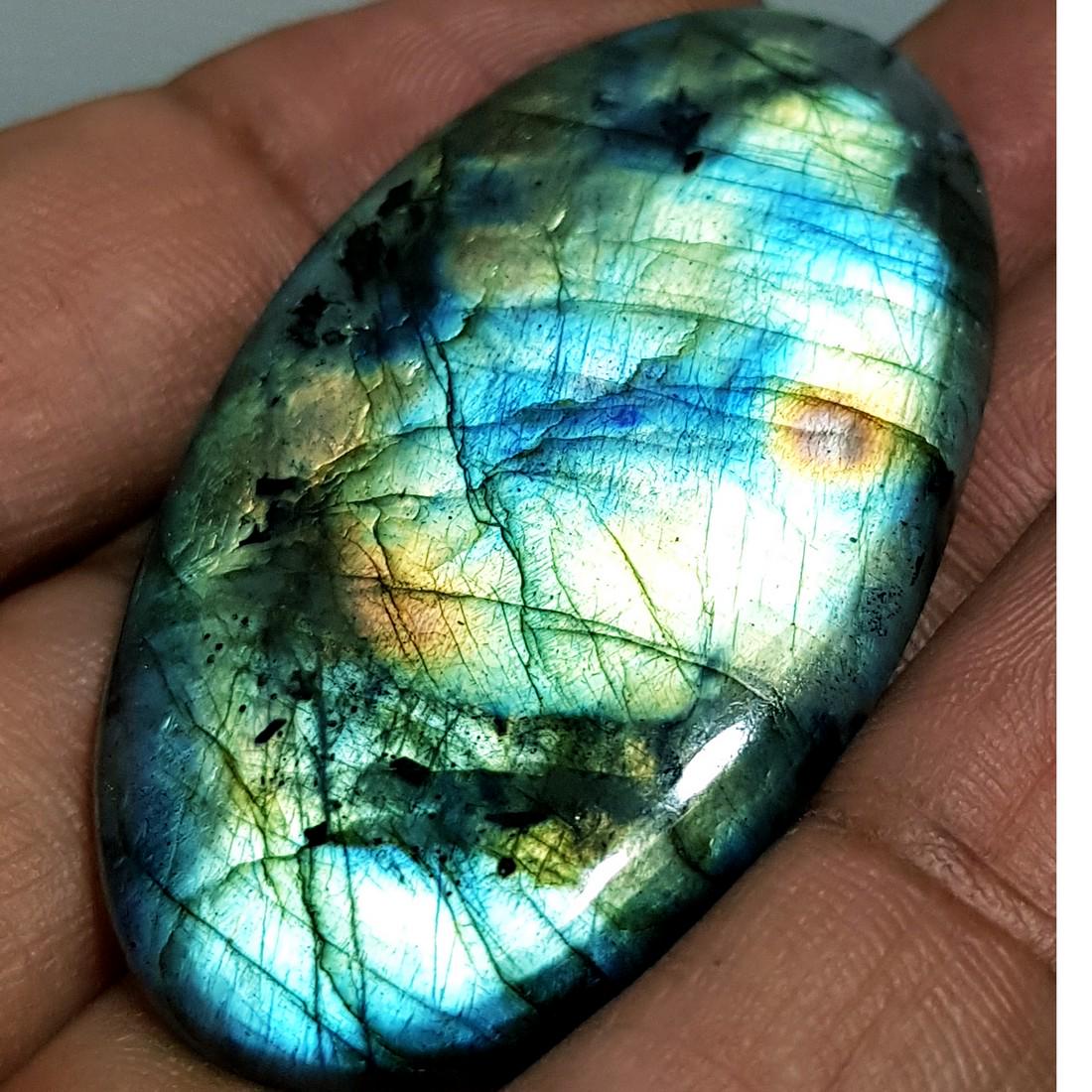 69.46 ct Natural Labradorite: No Reserve! Title: 69.46 ct Natural Labradorite Color/Clarity: Opaque Gemstones: Gemstones Carat Weights: 69.46 Size/Dimensions: 50.35 x 28.94 x 5.78 Additional Information: Oval - USA Shipping:
