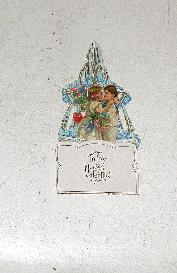 19th CENTURY DIE CUT LITTLE COUPLE KISSING IN FRONT OF (1 of 3)