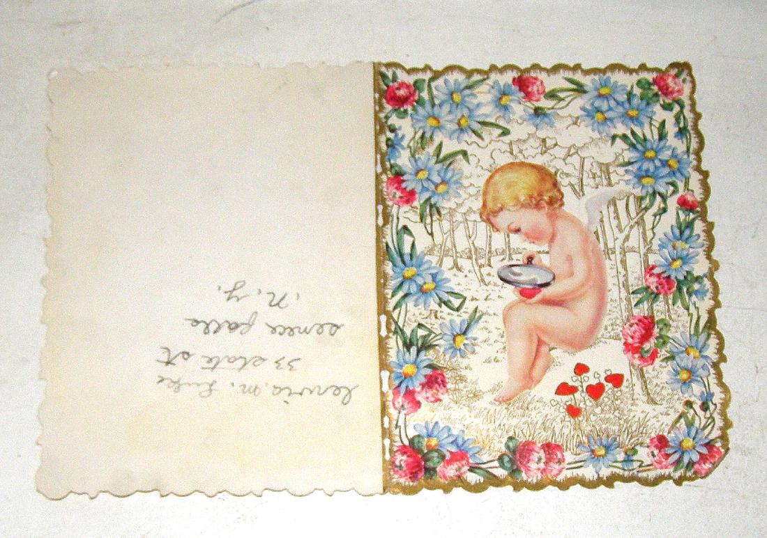 BABY ANGEL WITH WINGS LOOKING THRUOGH MAGNIFYING GLASS (1 of 2)