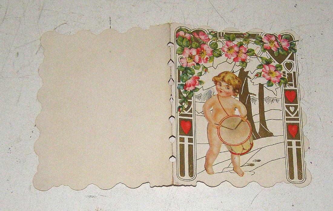 Unused Die Cut Cupid with Drum: No Reserve! Title: UNUSED DIE CUT VALENTINE OF DRUMMER BABY unknown probibly USA Subject: Valentines Day Description: Colorful early screen printing with Gold illumination. Shows a Bay Drummer surroun
