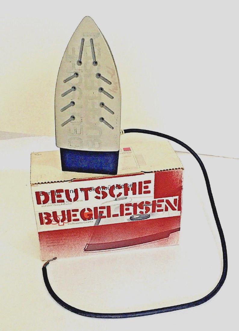 Georg Herold Deutche Buegeleisen 1990: Artist: Georg Herold Title: Georg Herold Deutche Buegeleisen 1990 Medium: Mixed media sculpture with paint Dimensions: 10 1/2" x 6 1/4" x 4 1/4" box, iron is 10" x 4 1/4" x 5" Description: Stenciled b