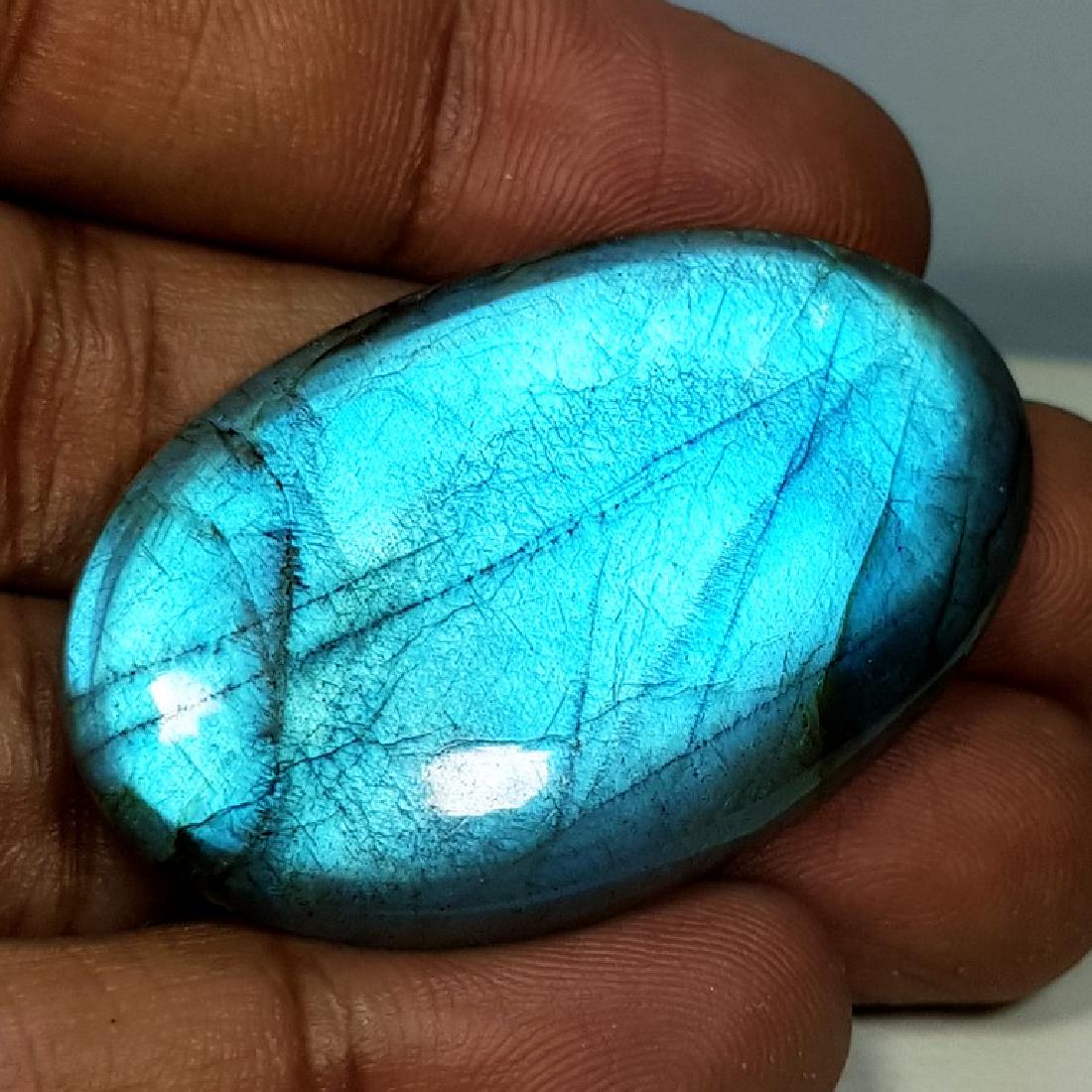 68.60 ct Natural Labradorite: No Reserve! Title: 68.60 ct Natural Labradorite Color/Clarity: Opaque Carat Weights: 68.6 Size/Dimensions: 43.65 x 26.28 x 7.31 Additional Information: Oval - USA Shipping: Worldwide: Flat-rate of $
