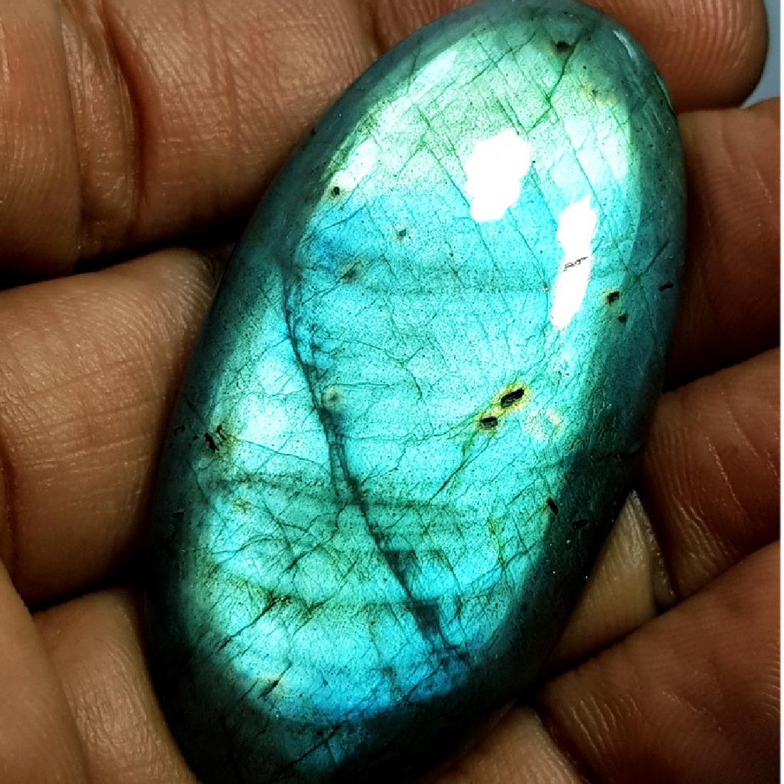 71.30 ct Natural Labradorite: No Reserve! Title: 71.30 ct Natural Labradorite Color/Clarity: Opaque Carat Weights: 71.3 Size/Dimensions: 49.90 x 25.66 x 6.59 Additional Information: Oval - USA Shipping: Worldwide: Flat-rate of $