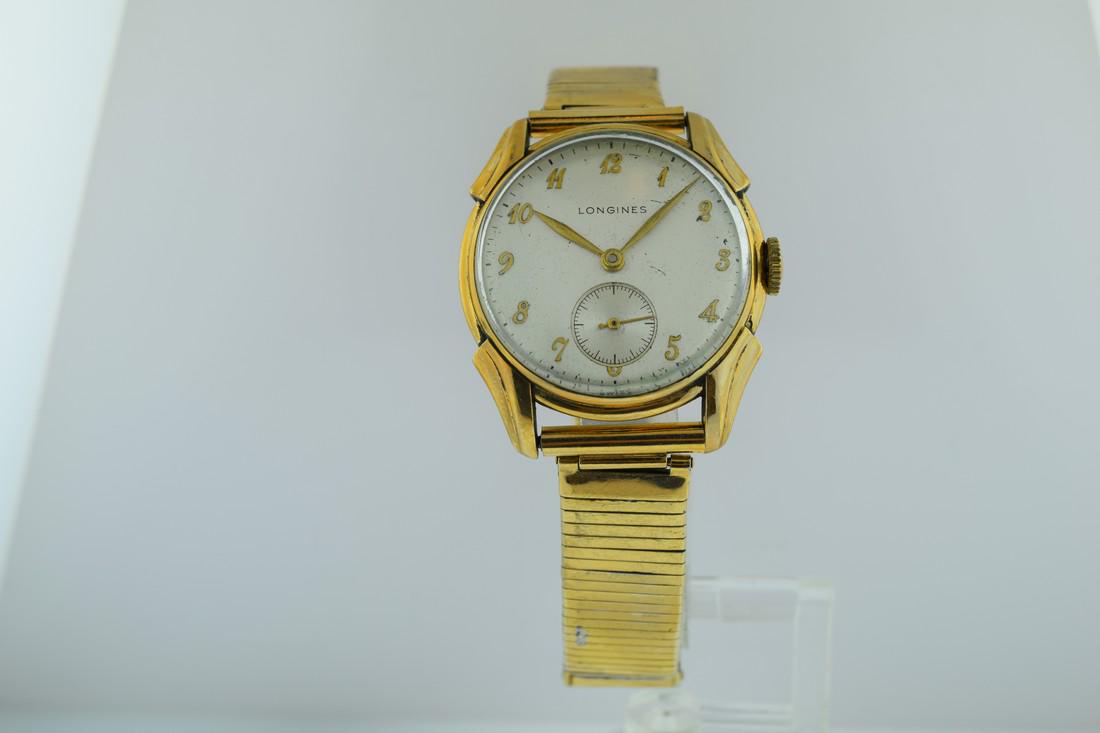 Longines 1940s Watch: Watch: Longines 1940s Watch Date: 1940’s Movement: Mechanical, hand winding Case Metal: Gold filled case Case Size: 30mm Strap/Bracelet Type: Gold filled Bracelet Length: 7.75 inches Dial: Sub secon