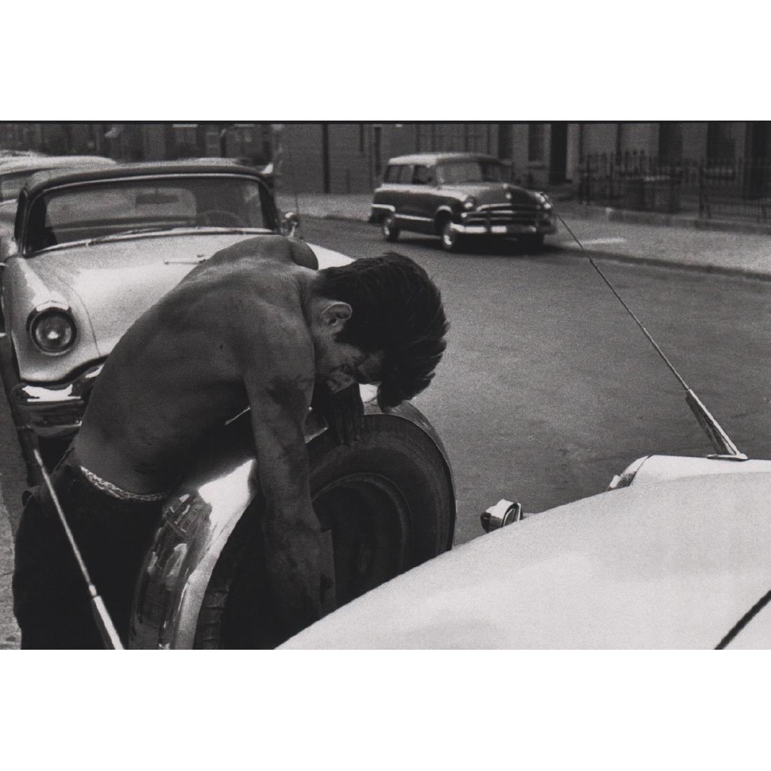 BRUCE DAVIDSON - Changing the tire: Artist: BRUCE DAVIDSON Print Title: Changing the tire Medium: Sheet-fed Gravure Printing Date: 1990's Printed in Japan Image Size: 8.25 x 5.5 inches Bruce Davidson (b. 1933) is an American photographe
