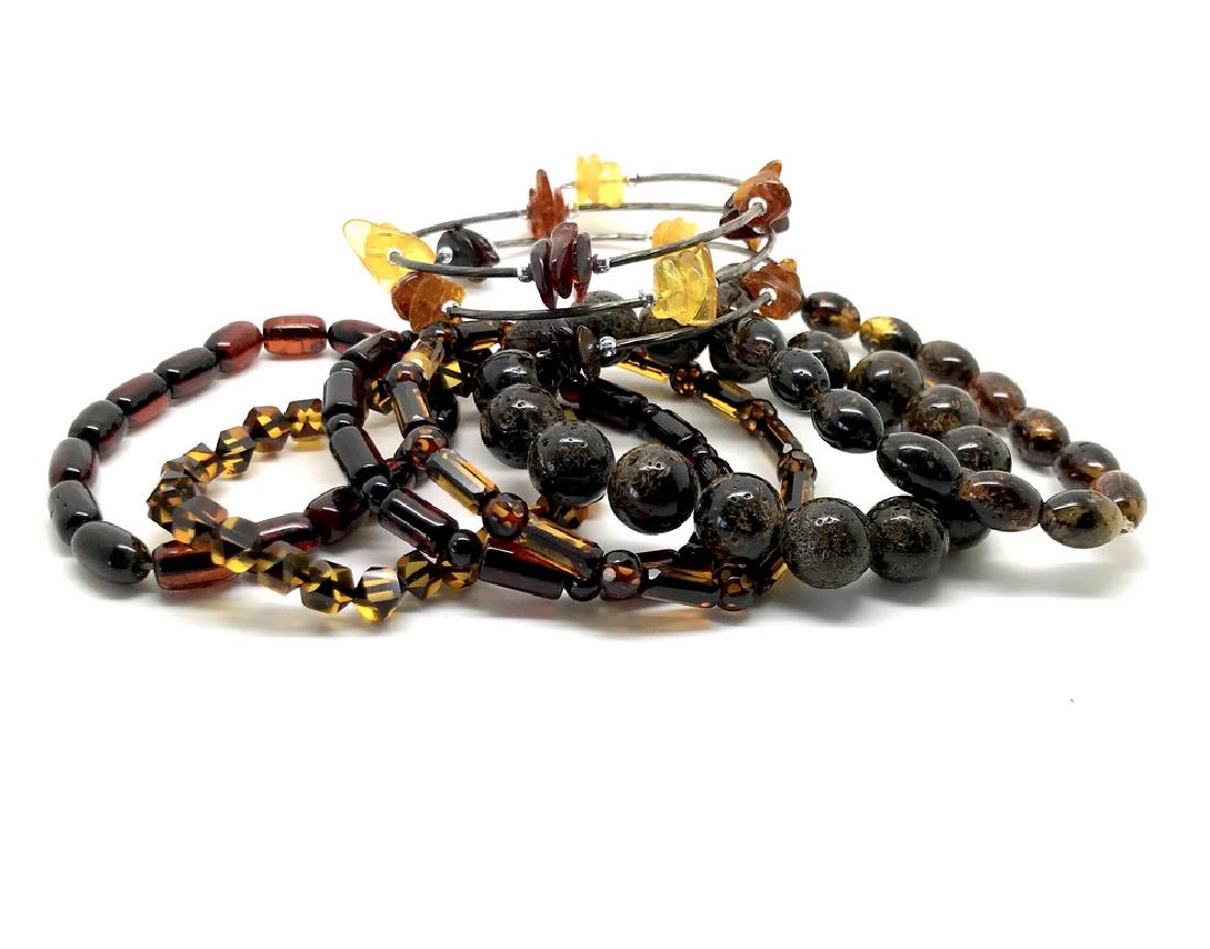 Baltic amber bracelets handcut beads , 7 pcs: Title: Baltic amber bracelets handcut beads , 7 pcs Gemstones: Baltic amber Weight: 44.6 grams Size: handcut and carved ambed beads of various shapes, bracelets size of 16 cm Additional Information: v