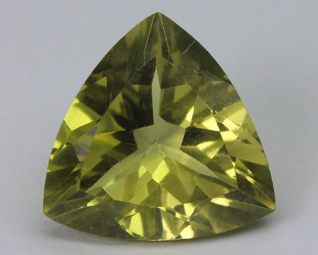 15.60 Ct Natural Lemon Quartz: No Reserve! Gemstone: Natural Lemon Quartz Origin: Brazil Weight: 15.60 Ct Measurements: 18.1x18.1x10.2 mm Shape / Cut: Trillian Cut Color : Yellowish Green Transparency: transparent Clarity: VS Shi