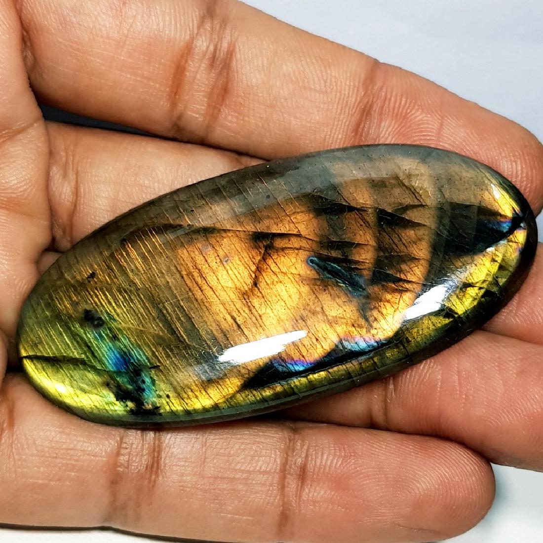 105.30 ct Natural Labradorite: No Reserve! Title: 105.30 ct Natural Labradorite Color/Clarity: Opaque Gemstones: Gemstones Carat Weights: 105.3 Size/Dimensions: 62.30 x 29.70 x 6.50 Additional Information: Oval - USA Shipping: