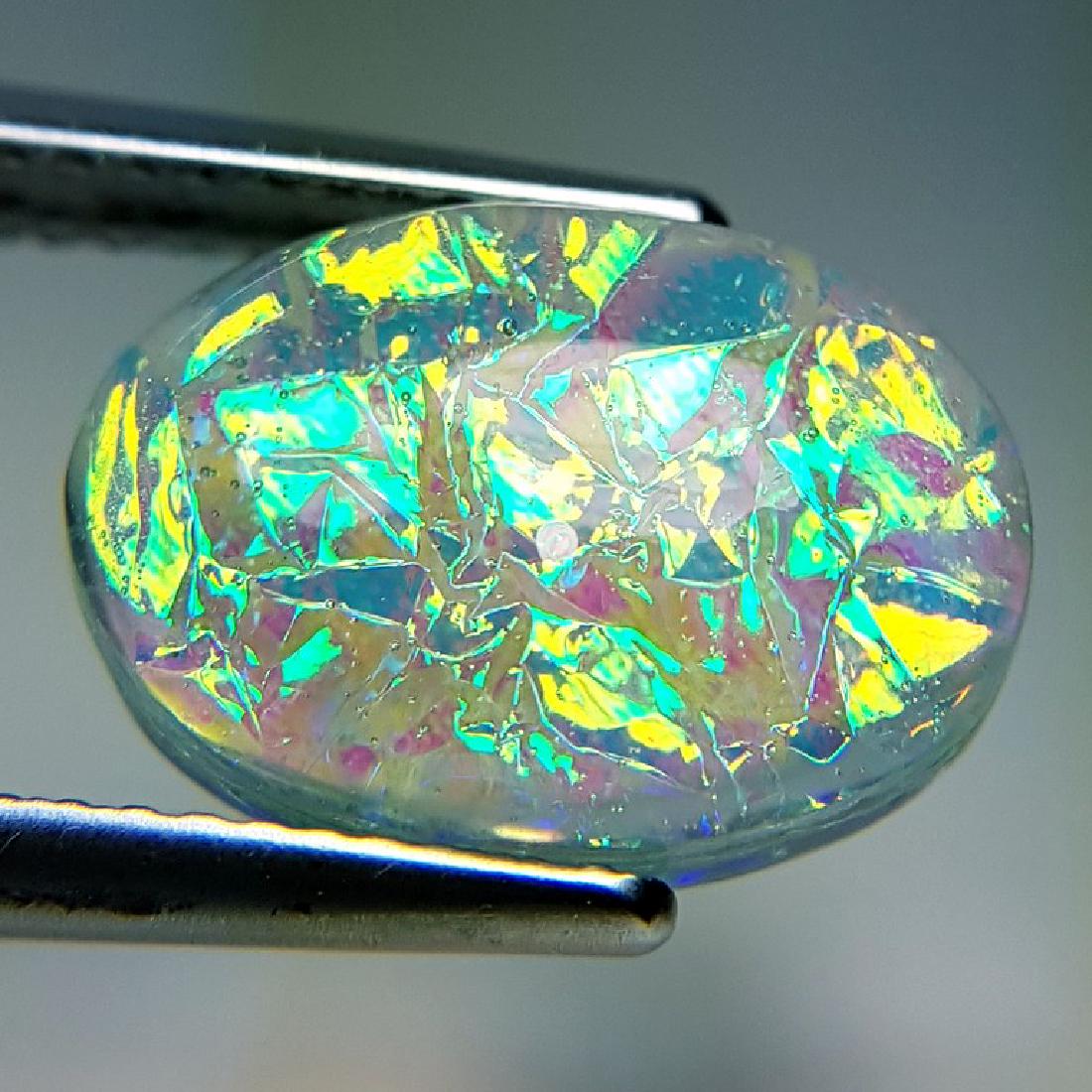 5.95 ct Australian Doublet Opal: No Reserve! Title: 5.95 ct Australian Doublet Opal Color/Clarity: Semi Transparent Gemstones: Gemstones Carat Weights: 5.95 Size/Dimensions: 13.95 x 10.00 x 5.70 Additional Information: Oval - Austral