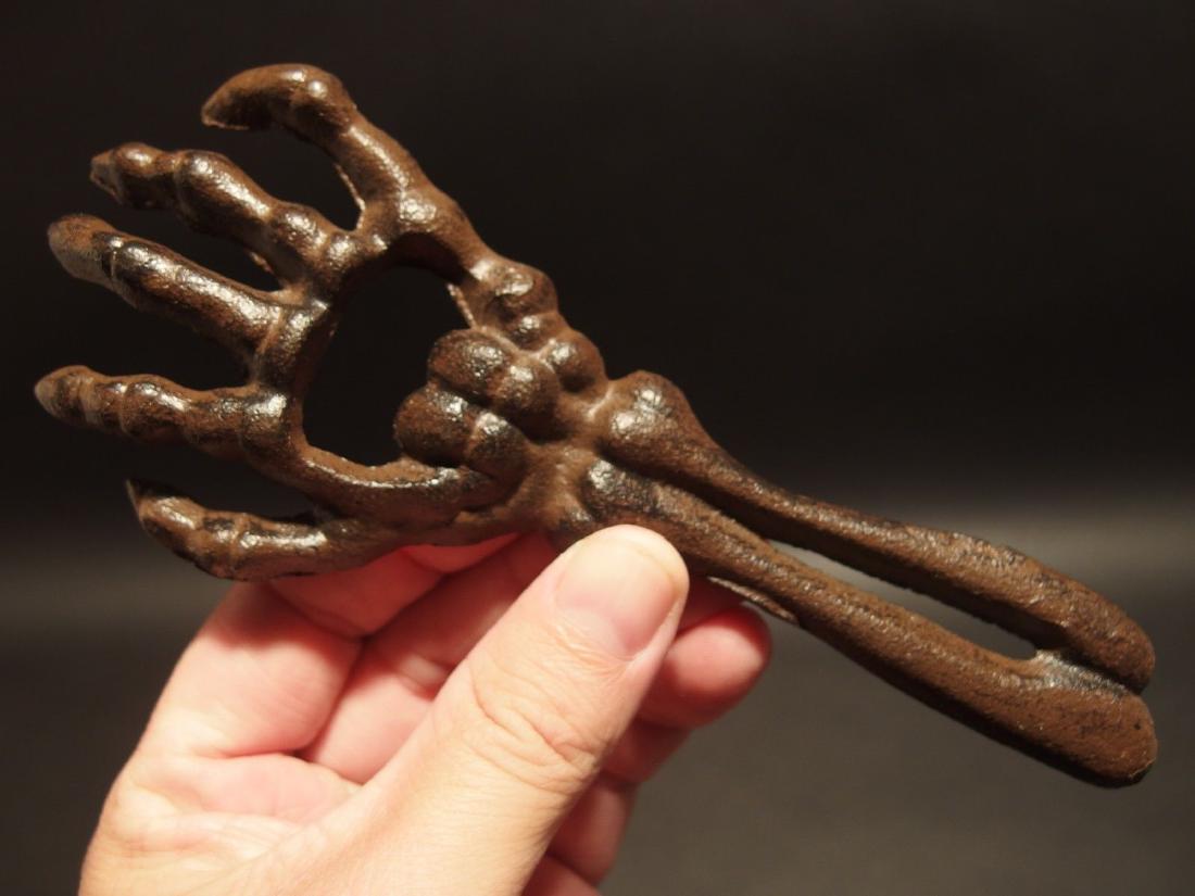 Cast Iron Halloween Beer Cap Skeleton Hand Bottle: 6 3/4" Long x 2 3/4" Wide Great reproduction cast iron bottle opener. This piece was made to look just like an antique, but is new. As you see in the images it is in the form of a skeleton hand. Great