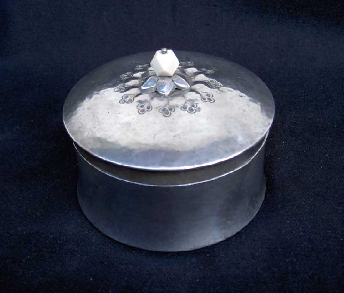Danish Deco: Skonvirke pewter box by Just Andersen: Reserve Reduced! Hand hammered pewter box and lid by Danish Deco or Skonvirke style, by Just Andersen (1884-1943). The side of the box concave, the lid with a stylized flower and a white Bakelite (?)