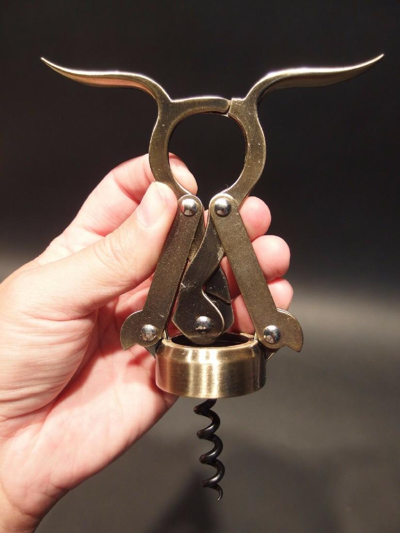 Double Lever Corkscrew Wine Bottle Opener: Antique Vintage Style Empire Double Lever Corkscrew Wine Bottle Opener 6 1/2" Tall x 4 7/8 Wide Reproduction double lever corkscrew likely made from zinc and steel. Was made to look just like an antiq