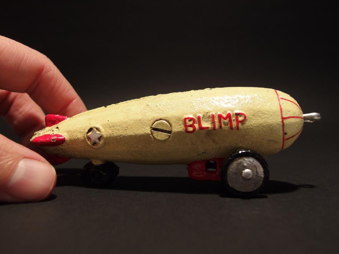 Mini Cast Iron Blimp Zeppelin Pull Toy: 5" Long 1 3/4" Tall Great little reproduction cast iron pull toy. All cast iron hand painted, slightly distress as shown in the images. Certainly looks old! Reserve: $15.00 Shipping: Domestic: Flat-ra