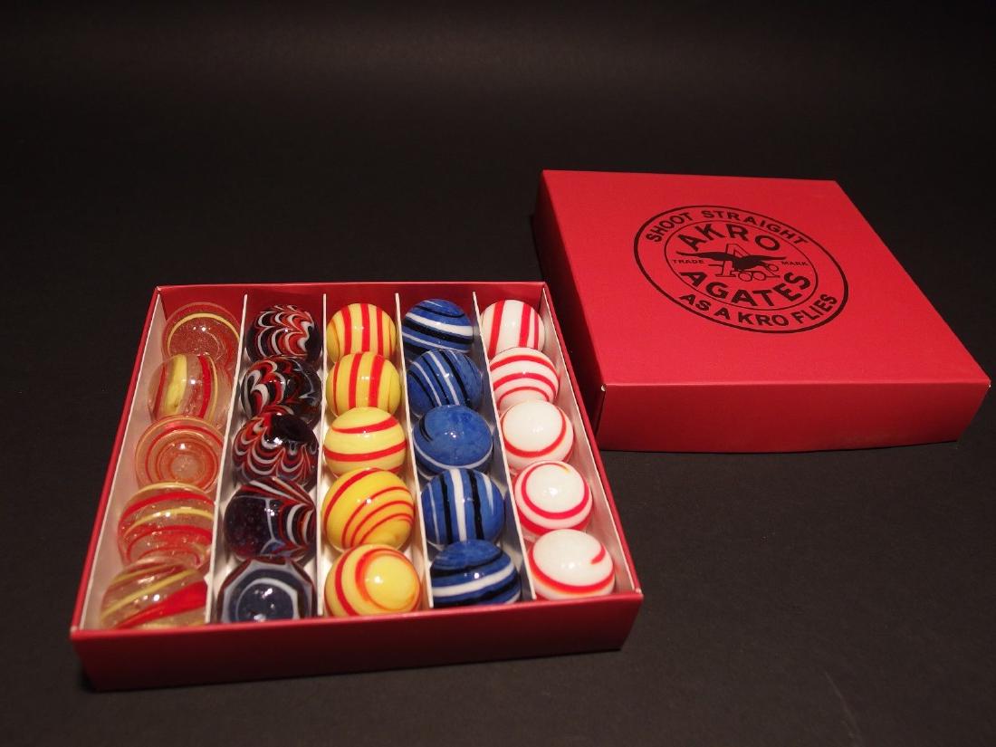 Akro Agates Marble set w Box Red Stripe: Description 25 1" marbles with box as shown. Wonderful reproduction Akro Agate branded box with marbles as shown. As mentioned this is just a reproduction/reminder of classic and highly sought after b