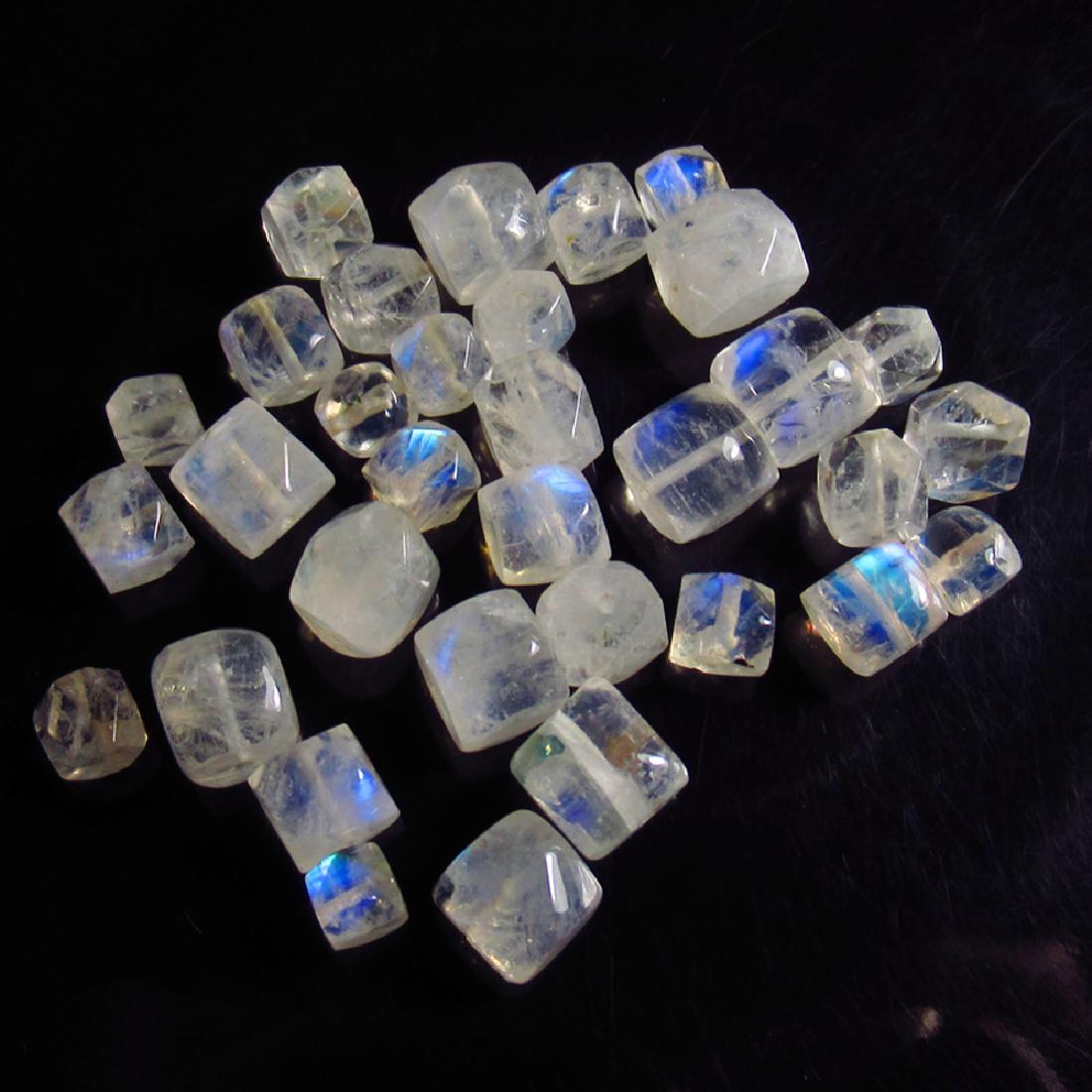 41.61 Ctw Natural 33 Drilled Blue Moonstone Square: No Reserve! Title: 41.61 Ctw Natural 33 Drilled Blue Moonstone Square Beads Stone Clarity: Transparent Gemstones: Natural Blue Moonstone Beads Carat Weights: 41.61 Size/Dimensions: 3.9x3.7 to 6.3x6.0 