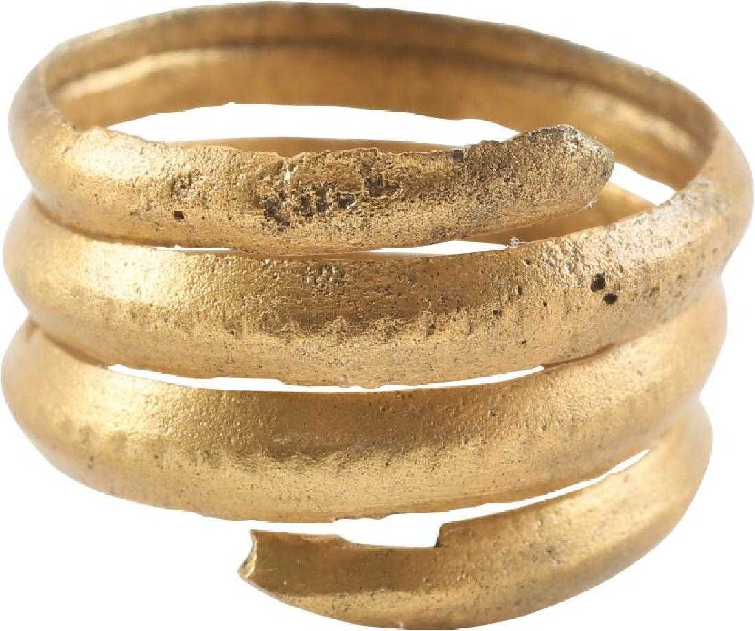 FINE VIKING COIL RING, 10th CENTURY A.D. SIZE 9: Gilt bronze. Over three full coils span just under ½” width. Size 9. Made by the lost wax process. The coil form was very popular in Viking culture. Professionally refurbished with the gold overlay