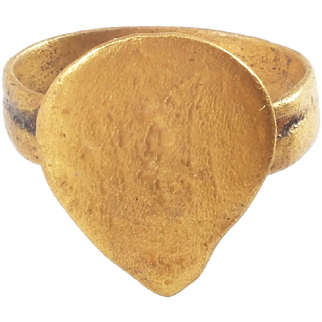 VIKING WARRIOR'S HEART RING C.900-1050 A.D., SIZE 9.: Gilt bronze. Size 9. Large 5/8” finely formed heart bezel of early style, with uncusped top. Broad flat band. The heart stood for bravery, fortitude, loyalty, integrity, all attributes of the Viking
