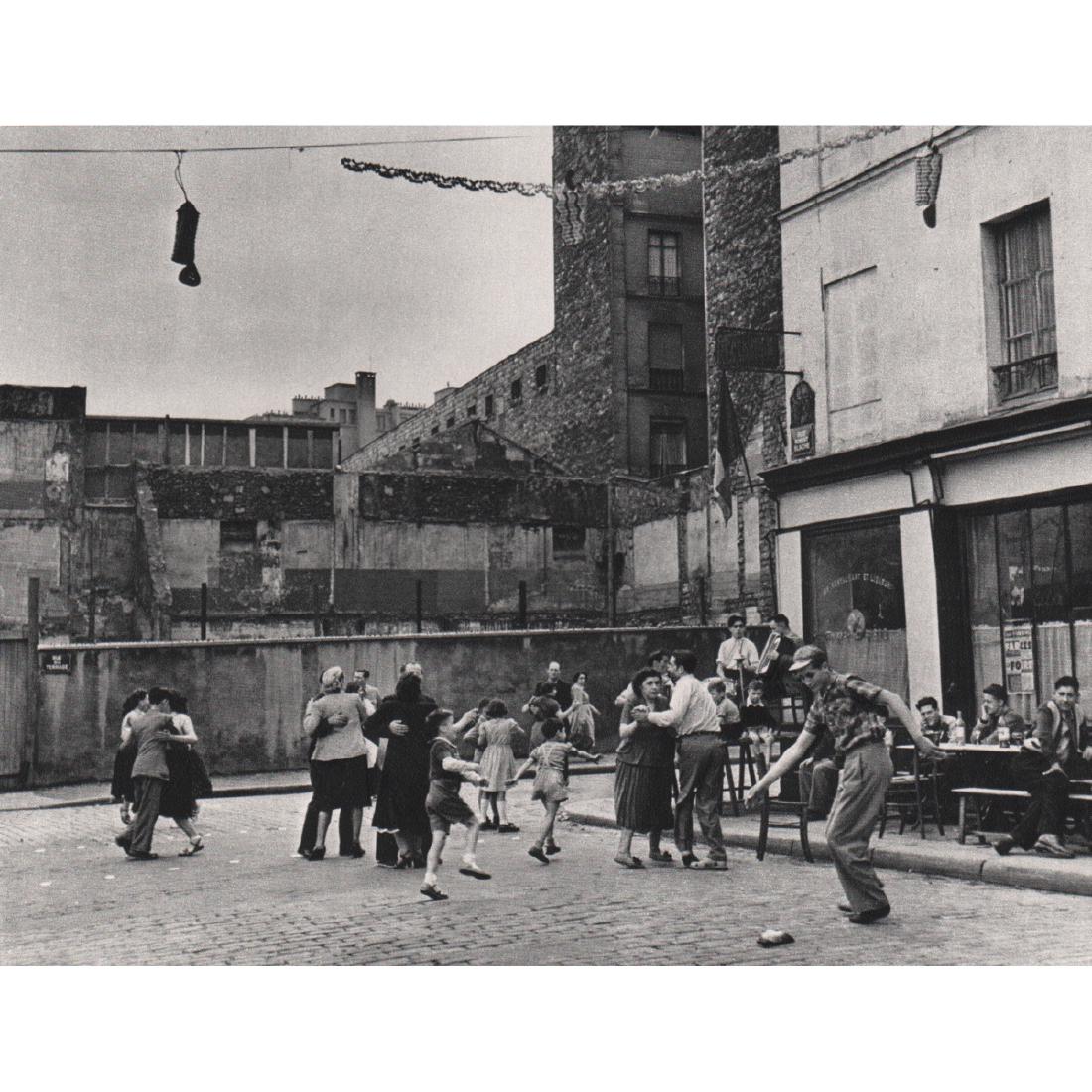 ROBERT DOISNEAU - Rue Robert Blache on Bastille Day,: Artist: ROBERT DOISNEAU Print Title: Rue Robert Blache on Bastille Day, 1951 Medium: Sheet-fed Gravure Printing Date: 1970's Printed in France Image Size: 7 x 5.5 inches Robert Doisneau (1912-1994) wa