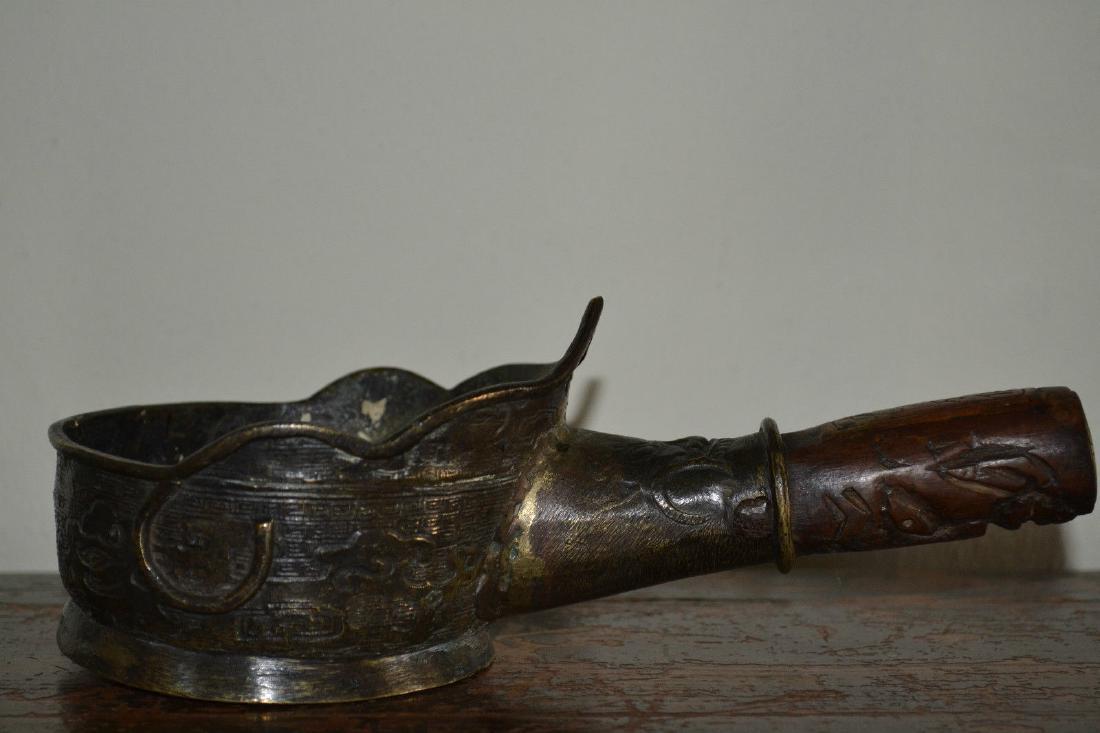 Antique 19th Century Chinese Bronze/Wood Silk Iron: Antique 19th century Chinese bronze and wood silk iron, c 1890 . The main body is nicely cast and decorated and there are character or seal marks on the handle which has an embossed brass end stop.It