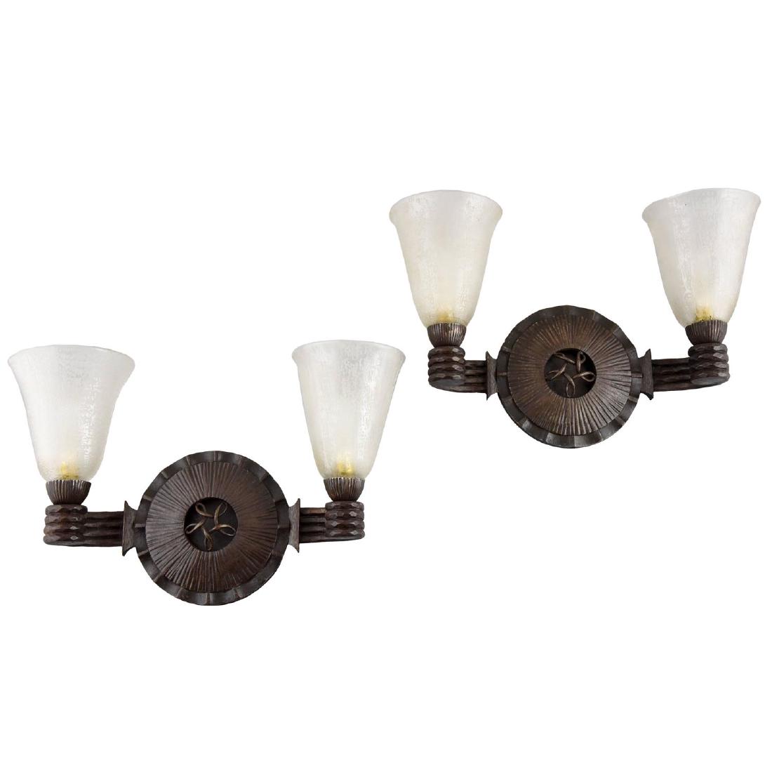 Nics frères & Daum: Art Deco glass and iron sconces: A pair of high quality Art Deco wrought iron wall lights designed by Nics Freres with etched glass shades signed by Daum Nancy France. This model is illustrated on page 327 of " Le Luminaire”