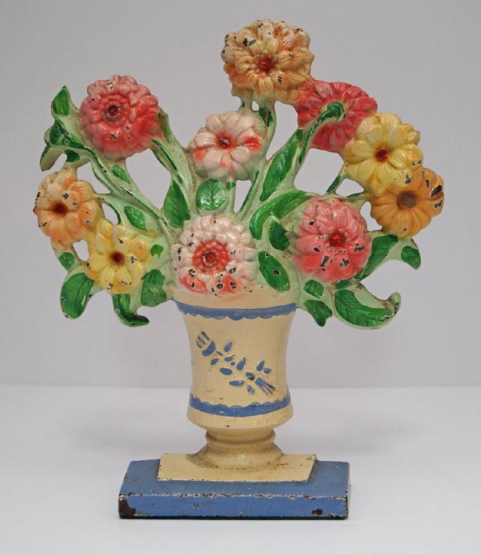 Antique Zinnias Flower Cast Iron Hubley Doorstop: Title: Antique Zinnias Flower Cast Iron Hubley Doorstop Date: Circa 1930's. Dimensions: 9 3/4' tall x 8 1/2" wide. Additional Information: Lovely mixture of assorted zinnia flowers in urn with light b