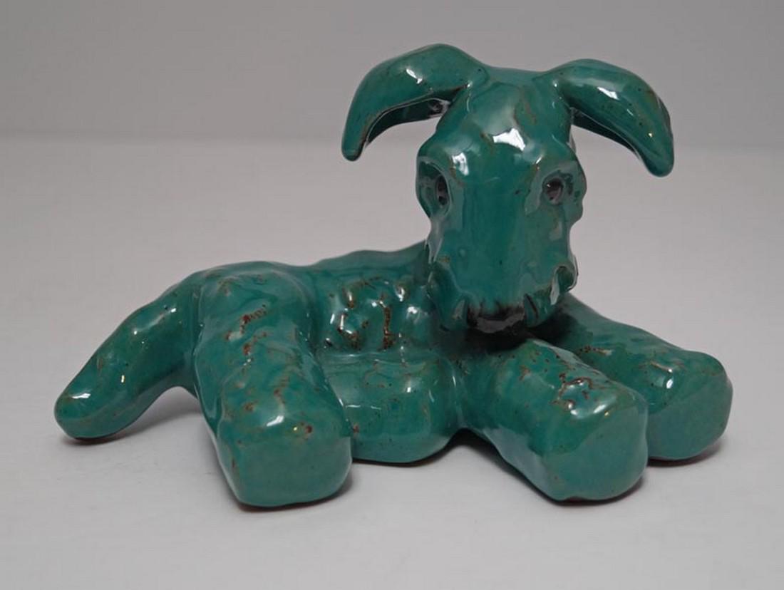 Lying Down Terrier Dog Czech Pottery Figurine: Title: Lying Down Terrier Dog Czech Pottery Figurine Date: Circa 1930’s-40’s Dimensions: 3 7/8" tall x 6 1/4" long x 3 1/4" wide. Additional Information: A Lying Down Terrier Czech Pottery Figurin