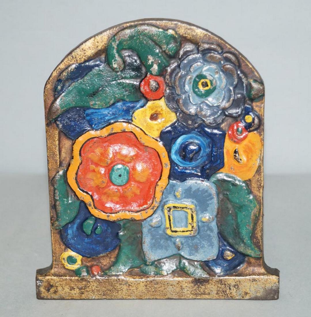 Antique Art Deco Flowers Cast Iron Doorstop: Title: Antique Art Deco Flowers Cast Iron Doorstop Date: Circa 1920's. Dimensions: 6 5/8" tall x 5 3/4" wide. Additional Information: An Antique Cast Iron Art Deco Flowers Doorstop. Fun assorted color