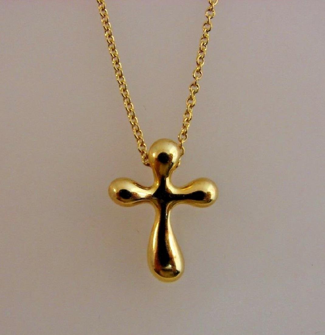 TIMELESS Tiffany & Co. Elsa Peretti 18k Yellow Gold: Tiffany & Co. Elsa Peretti 18k Yellow Gold Cross Necklace · This is a must for a collector. The weight is 3.7 grams. The length of chain is 16 inches. The length of pendant is 5/8 of an inch. Reserve
