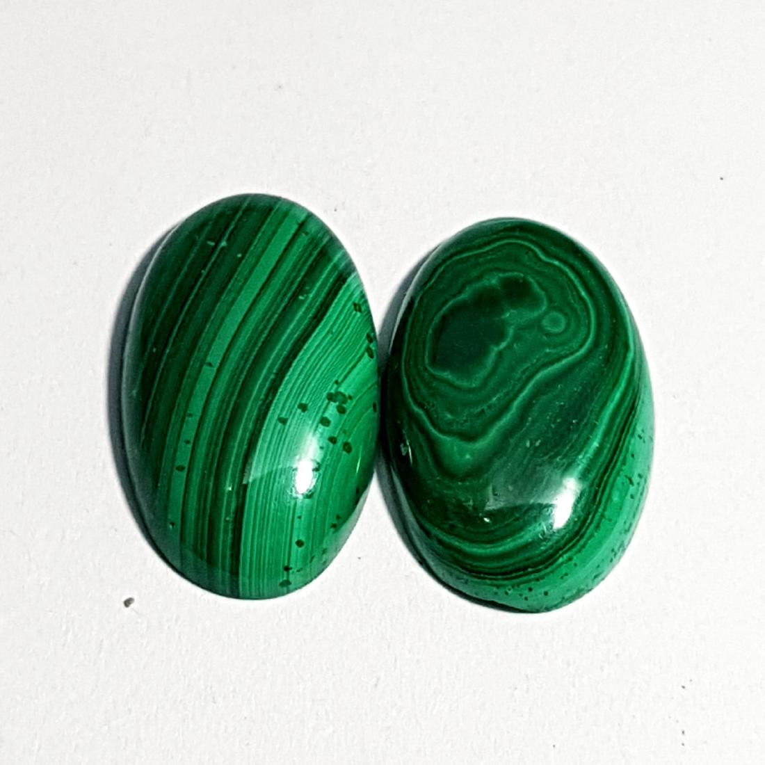 2 Pcs of Natural Malachite Oval Cut - 22.00 ct: No Reserve! Title: 2 Pcs of Natural Malachite Oval Cut - 22.00 ct Color/Clarity: Opaque Gemstones: Gemstones Carat Weights: 22 Size/Dimensions: 19.35 x 12.30 x 4.00/19.70 x 11.70 x 4.40 Additional Inf