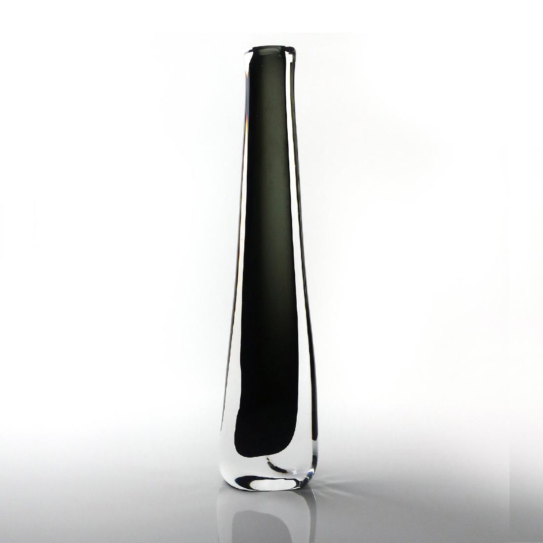 Tall Smoked Glass Vase by Nils Landberg for Orrefors: A smoked glass vase designed by Nils Landberg for Orrefors’ Dusk line. This beautiful, high-polished vase has a lengthy, slender silhouette and a smokey interior enveloped by an outer translucent la