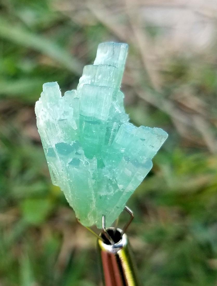 15 Carats Beautiful Blu Tourmaline Crystal: Title: 15 Carats Beautiful Blu Tourmaline Crystal Gemstones: Tourmaline Carat Weights: 15 Carats Size/Dimensions: 25x16x10 MM Additional Information: Natural Reserve: $40.00 Shipping: Domestic: