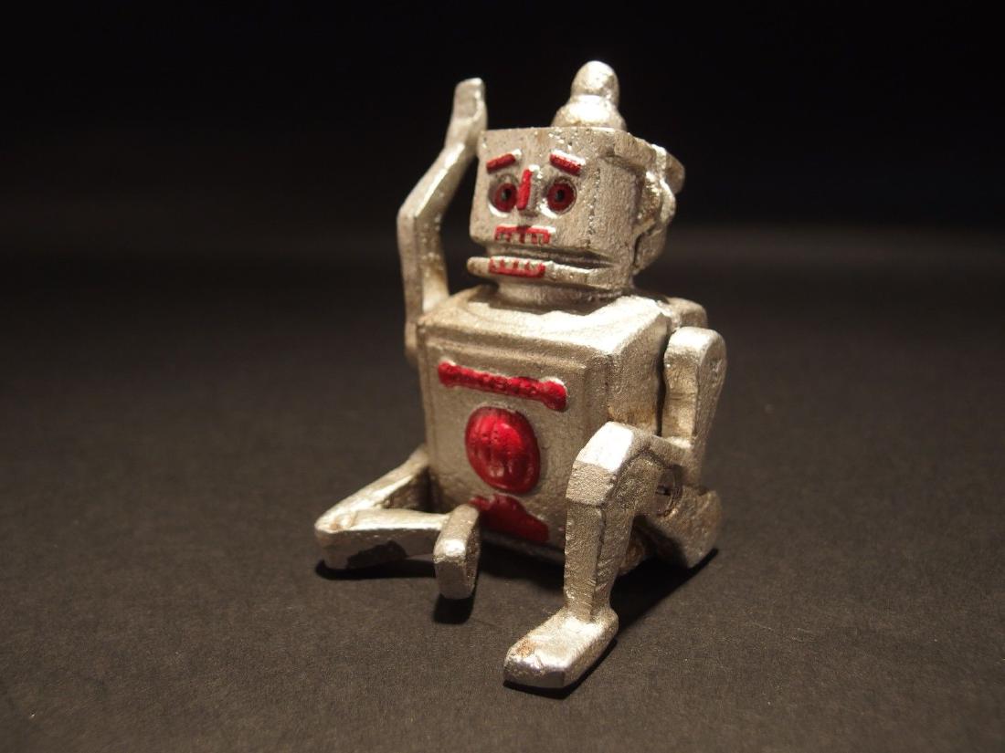 Mini Cast Iron Silver Robert the Robot Toy Paperweight: 2 L x 2.5 W x 3.5 H Great little reproduction cast iron robot. All cast iron, hand painted, slightly distress as shown in the images. Certainly looks old! This looks alot like the mechanical coin bank