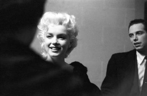 Marilyn Costume Fitting: Artist: Ed Feingersh Title: Marilyn Costume Fitting Medium: Silver Gelatin Year: 1955 Height/Width: 12 x 16 in Description: Movie star Marilyn Monroe gets fitted for her costume in a dressing room