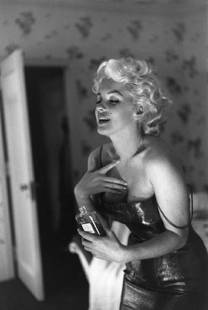 Marilyn Getting Ready To Go Out New York: Artist: Ed Feingersh Title: Marilyn Getting Ready To Go Out New York Medium: Silver Gelatin Year: 1955 Height/Width: 16 x 12 in Description: Actress Marilyn Monroe gets ready to go see the play