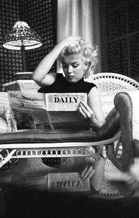 Marilyn Relaxes In A Hotel Room: Artist: Ed Feingersh Title: Marilyn Relaxes In A Hotel Room Medium: Silver Gelatin Year: 1955 Height/Width: 24 x 20 in Description: Actress Marilyn Monroe reads the newspaper ‘Motion Picture
