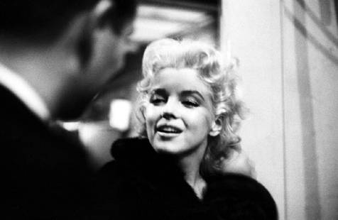 Marilyn Takes It To The Streets: Artist: Ed Feingersh Title: Marilyn Takes It To The Streets Medium: Silver Gelatin Year: 1955 Height/Width: 10 x 12 in Description: Movie star Marilyn Monroe is seen in a candid moment on the street