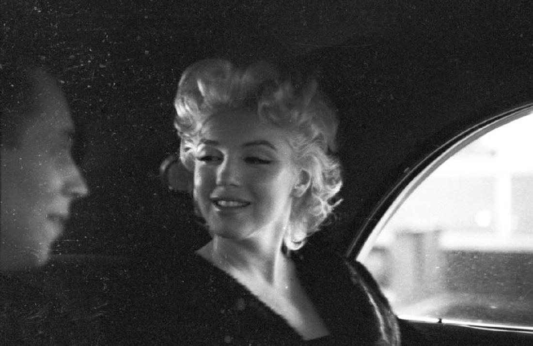 Marilyn With Dick Shepherd: Artist: Ed Feingersh Title: Marilyn With Dick Shepherd Medium: Silver Gelatin Year: 1955 Height/Width: 12 x 16 in Description: Actress Marilyn Monroe rides in the back of a car with Dick Shepherd in M