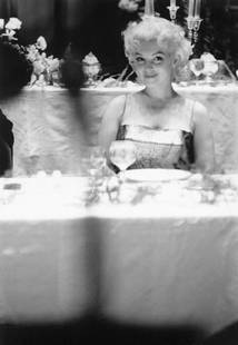 Your Table Awaits: Artist: Ed Feingersh Title: Your Table Awaits Medium: Silver Gelatin Year: 1955 Height/Width: 16 x 12 in Description: Actress Marilyn Monroe sits at a table in a restaurant in March 1955 in New York