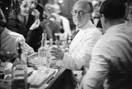 Barmen: Artist: Bert Hardy Title: Barmen Medium: Silver Gelatin Year: 1948 Height/Width: 12 x 16 in Description: Barmen at the Screenwriters’ Club in London. Original Publication: Picture Post – 4586