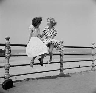 Blackpool Railings: Artist: Bert Hardy Title: Blackpool Railings Medium: Silver Gelatin Year: 1951 Height/Width: 40 x 40 in Description: July 14, 1951. Two women chatting on the railings in Blackpool. The picture was